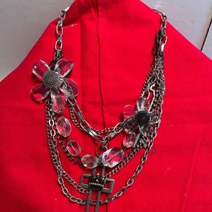 Multi strand necklace with cross and 2 flowers